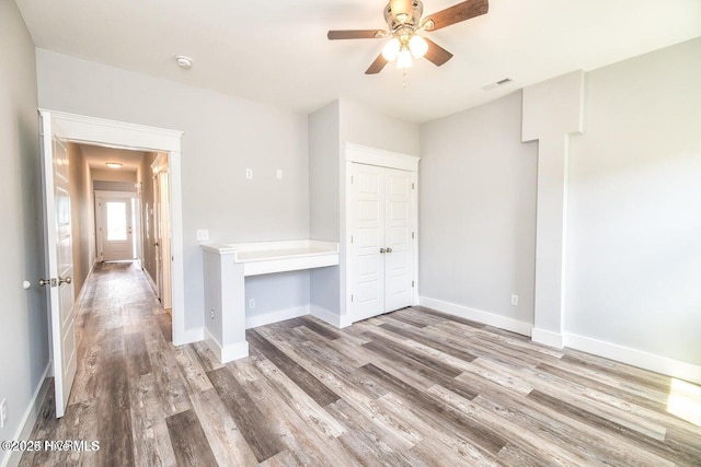 unfurnished room with ceiling fan and wood-type flooring