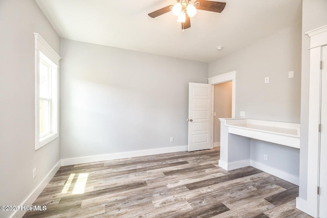 empty room with hardwood / wood-style flooring and ceiling fan