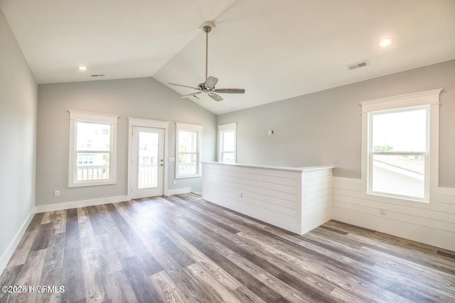 spare room featuring ceiling fan, wood-type flooring, and vaulted ceiling