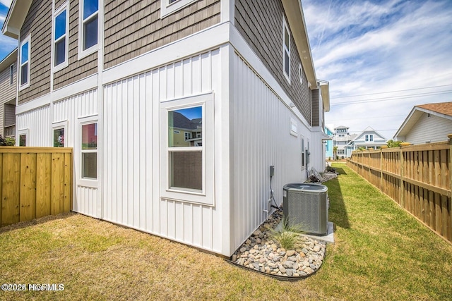 view of home's exterior featuring central AC unit and a lawn