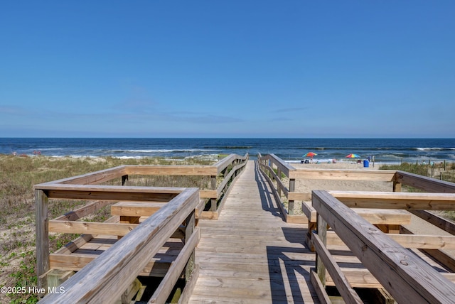 view of home's community featuring a beach view and a water view