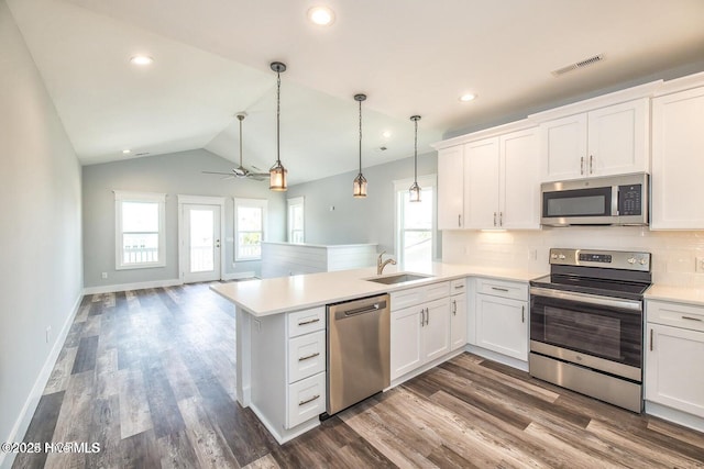 kitchen featuring stainless steel appliances, ceiling fan, sink, white cabinetry, and lofted ceiling