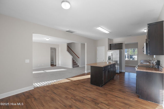 kitchen with a kitchen island, dark hardwood / wood-style flooring, sink, and appliances with stainless steel finishes