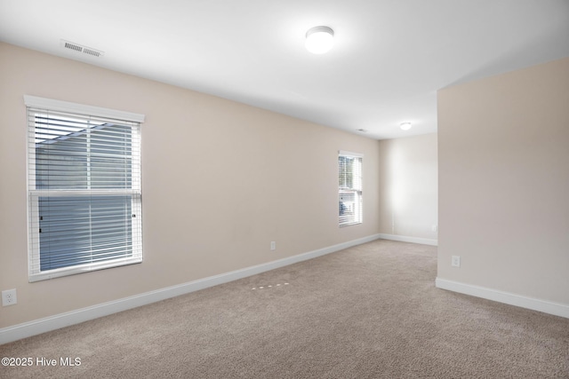 unfurnished room featuring light colored carpet