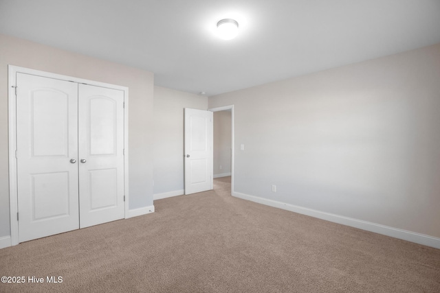 unfurnished bedroom featuring a closet and carpet floors