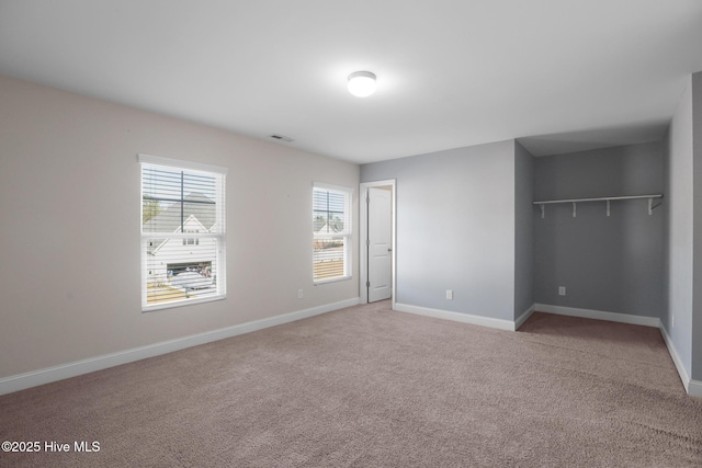 unfurnished bedroom with carpet floors and a closet