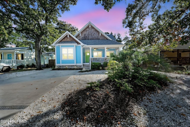 112 NE 28th St, Oak Island, NC 28465 - view of front of house featuring a porch