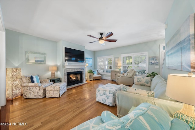 living room with a fireplace, hardwood / wood-style floors, and ceiling fan