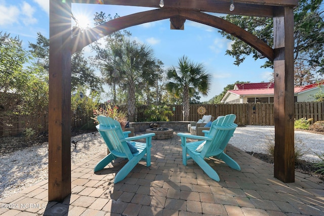 112 NE 28th St, Oak Island, NC 28465 - fenced backyard with an outdoor fire pit and a patio area