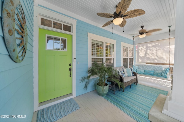 112 NE 28th St, Oak Island, NC 28465 - view of exterior entry with a porch and ceiling fan