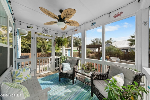 sunroom / solarium featuring ceiling fan