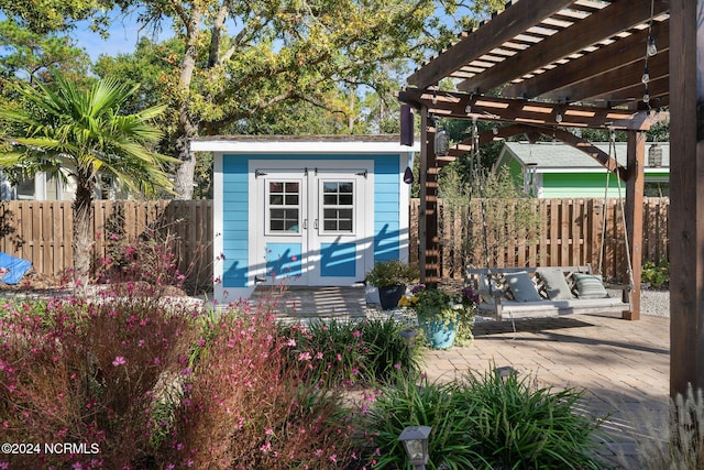 view of outdoor structure with outdoor lounge area and a pergola