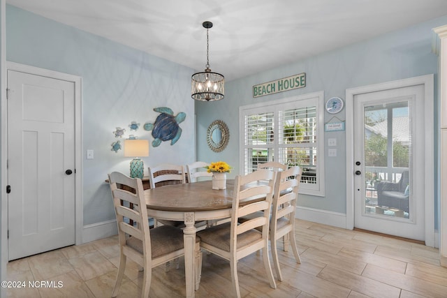 112 NE 28th St, Oak Island, NC 28465 - dining room featuring plenty of natural light, a chandelier, and baseboards