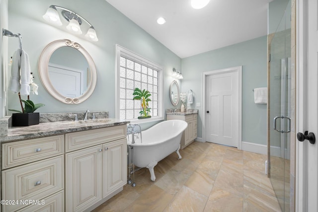 bathroom featuring vanity and independent shower and bath