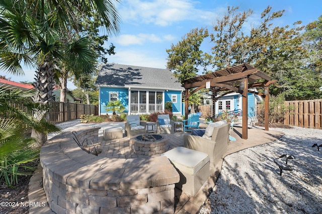112 NE 28th St, Oak Island, NC 28465 - fenced backyard featuring a pergola, a fire pit, an outdoor structure, and a patio