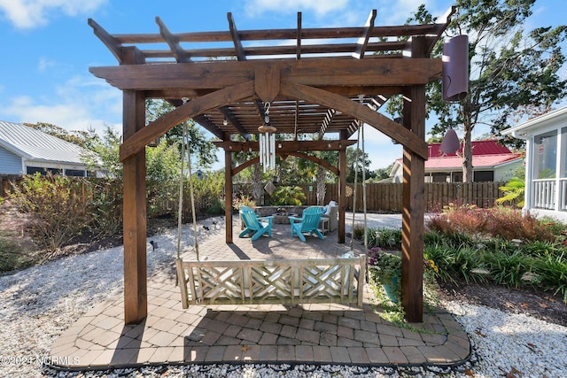 112 NE 28th St, Oak Island, NC 28465 - view of patio / terrace featuring a pergola and a fire pit