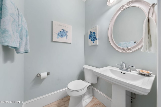 bathroom featuring tile patterned flooring, toilet, and sink