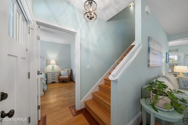 stairway featuring a chandelier and hardwood / wood-style flooring