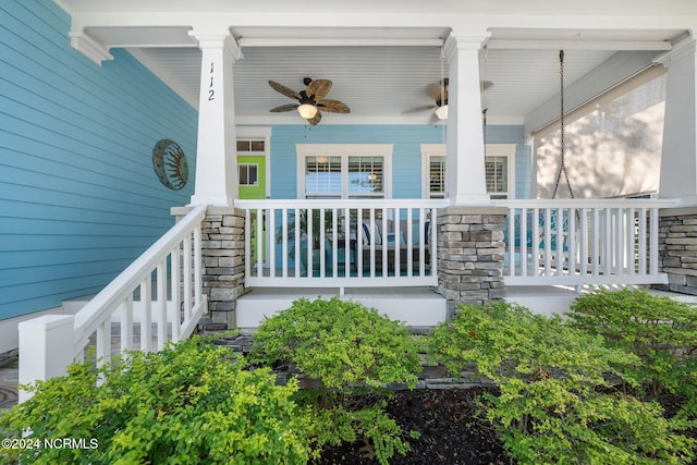 doorway to property featuring covered porch and ceiling fan