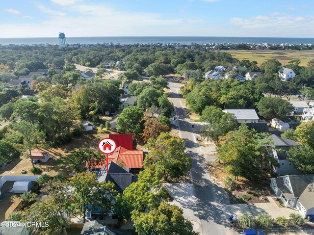 112 NE 28th St, Oak Island, NC 28465 - aerial view of property's location with a large body of water, nearby suburban area, and a tree filled landscape