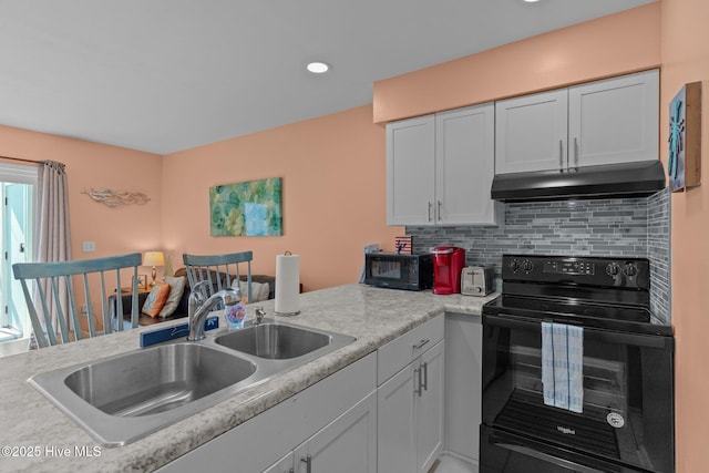 kitchen with black appliances, sink, and tasteful backsplash