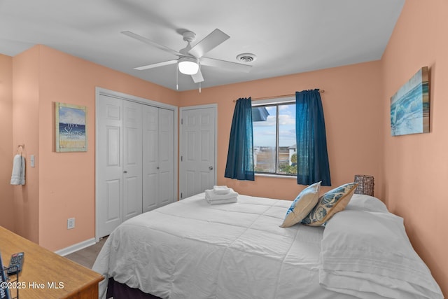 bedroom featuring ceiling fan and two closets