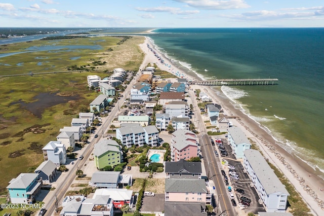 birds eye view of property featuring a water view and a beach view