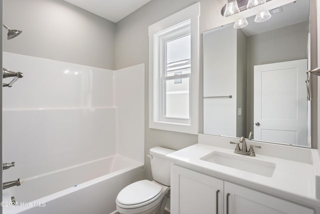 bathroom featuring toilet, washtub / shower combination, and vanity