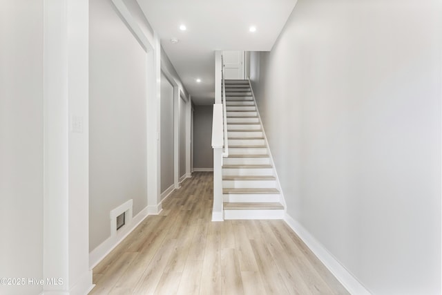 stairway featuring recessed lighting, visible vents, baseboards, and wood finished floors