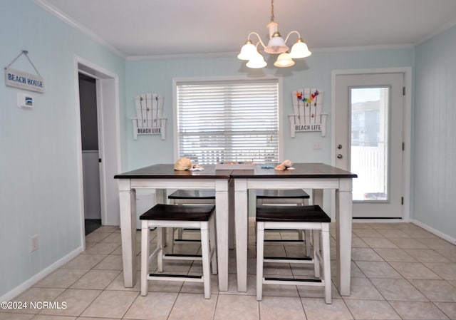 dining room featuring a notable chandelier, ornamental molding, and light tile patterned floors