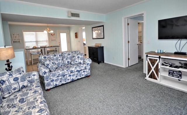 living room featuring carpet floors, ornamental molding, and a notable chandelier