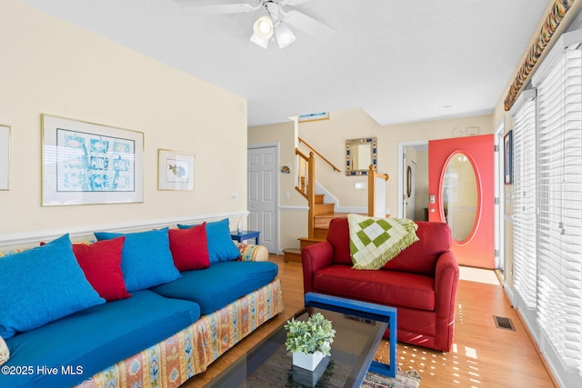 living room featuring ceiling fan and light hardwood / wood-style floors