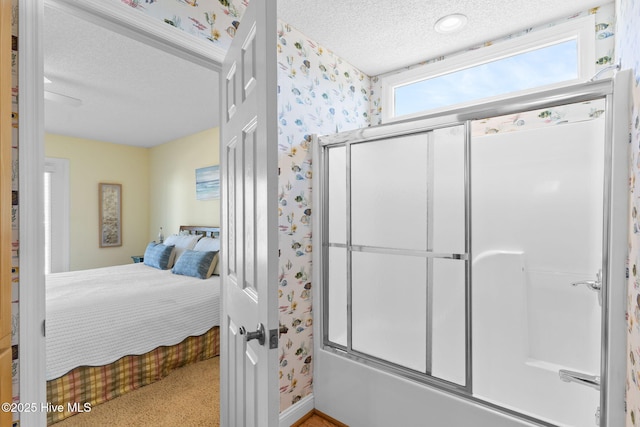 bedroom with a textured ceiling and light carpet