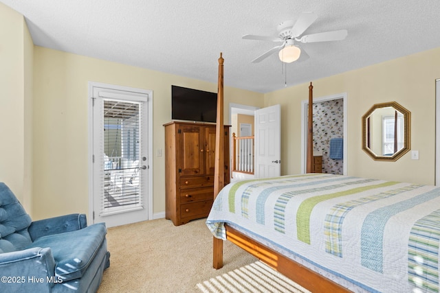 bedroom with ceiling fan, access to exterior, light colored carpet, and a textured ceiling