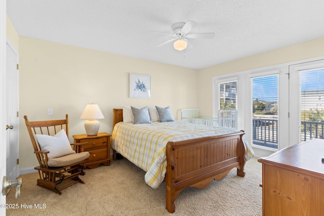 bedroom featuring ceiling fan, access to exterior, and light colored carpet