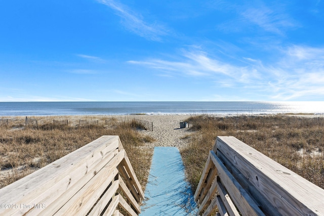 view of community with a water view and a view of the beach