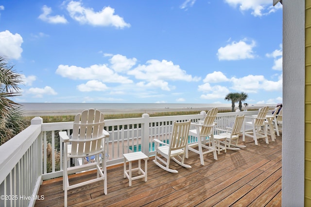 deck featuring a water view and a beach view