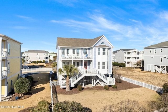 back of house with a porch and a balcony