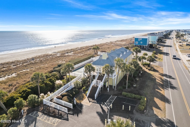 drone / aerial view featuring a view of the beach and a water view