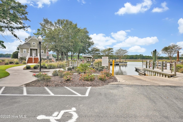 exterior space with a water view and a boat dock