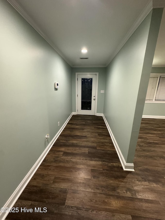 interior space featuring dark hardwood / wood-style flooring and ornamental molding