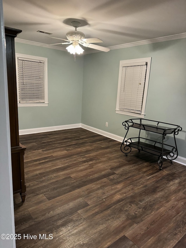 spare room featuring ceiling fan, dark hardwood / wood-style floors, and ornamental molding