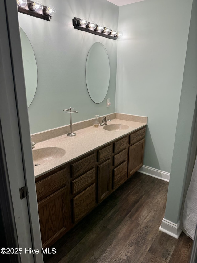 bathroom with hardwood / wood-style floors and vanity