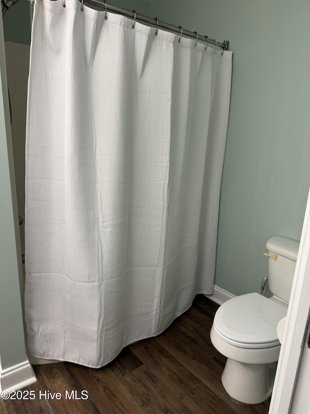 bathroom with hardwood / wood-style flooring and toilet