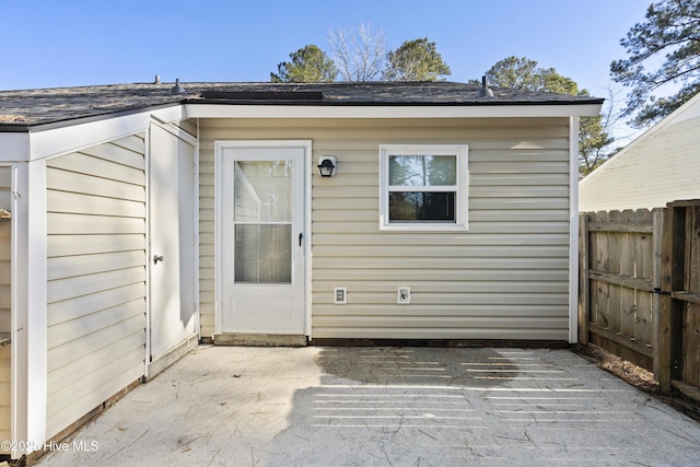 view of exterior entry with a patio area