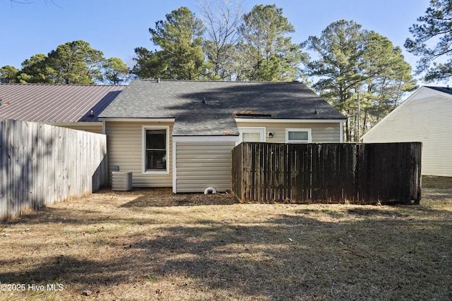 rear view of house featuring a yard and cooling unit