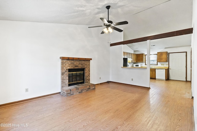 unfurnished living room featuring vaulted ceiling, light hardwood / wood-style floors, a brick fireplace, and ceiling fan