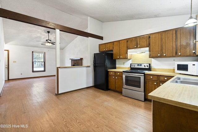 kitchen featuring black refrigerator, stainless steel electric stove, sink, pendant lighting, and vaulted ceiling with beams