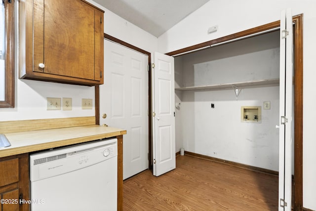 laundry area featuring hookup for a washing machine, light hardwood / wood-style flooring, and electric dryer hookup