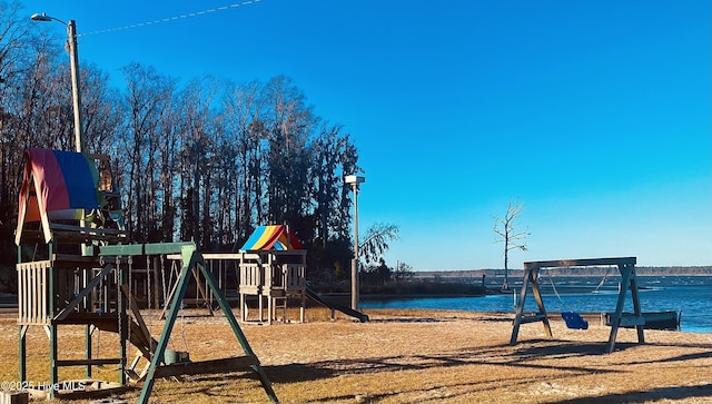 view of jungle gym with a water view